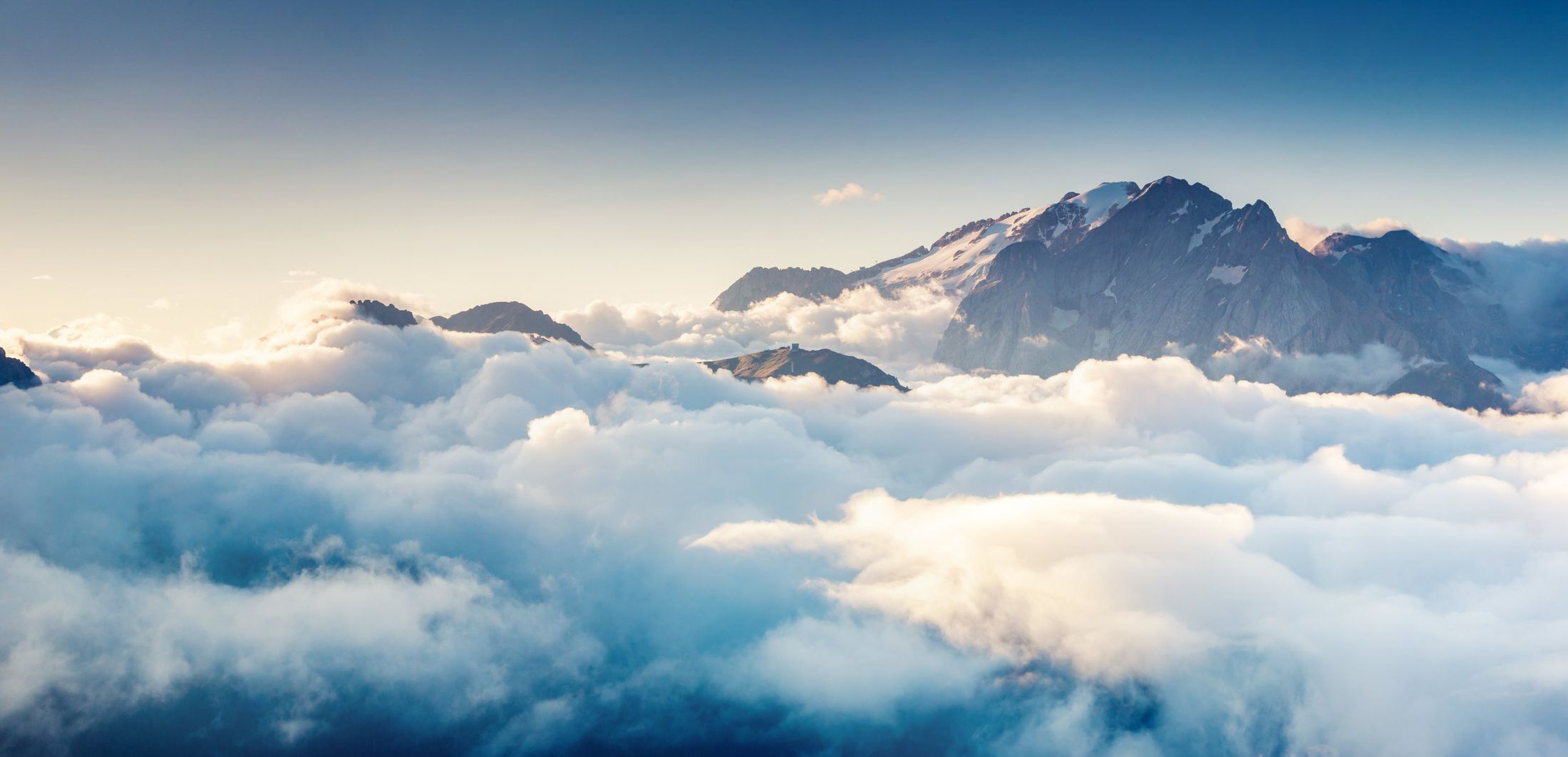 Mountain peaks rising above a sea of clouds